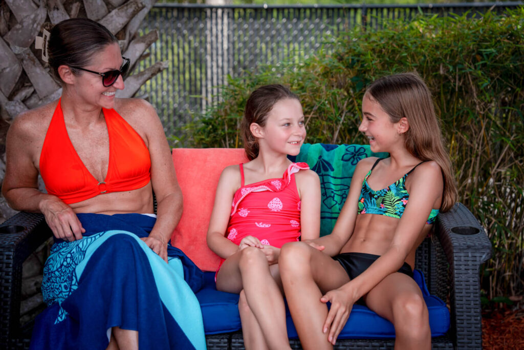Mom and 2 girls relax in a cabana
